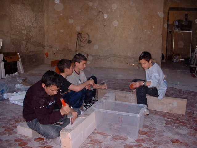Local kids cleaning gifted tiles